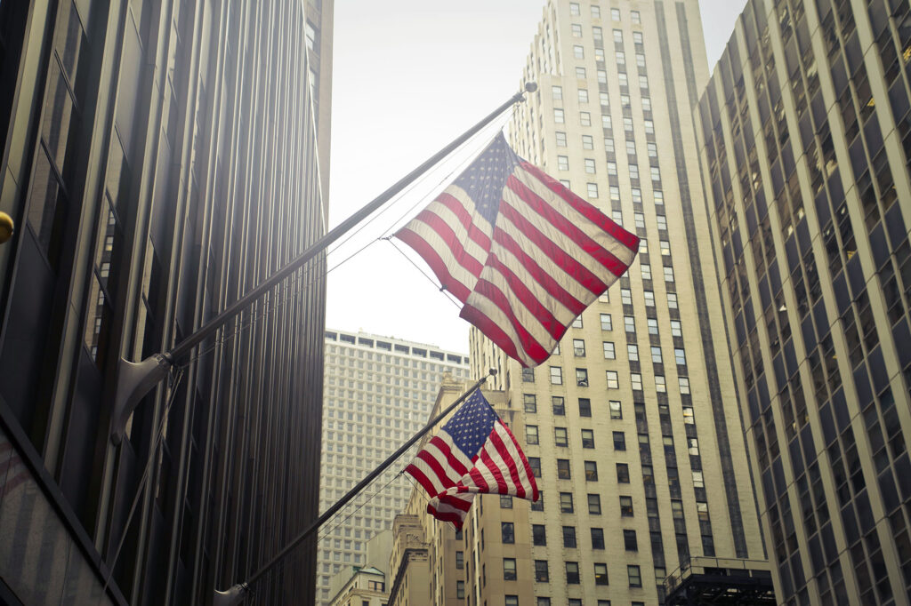 shot-two-american-us-flags-high-rise-building